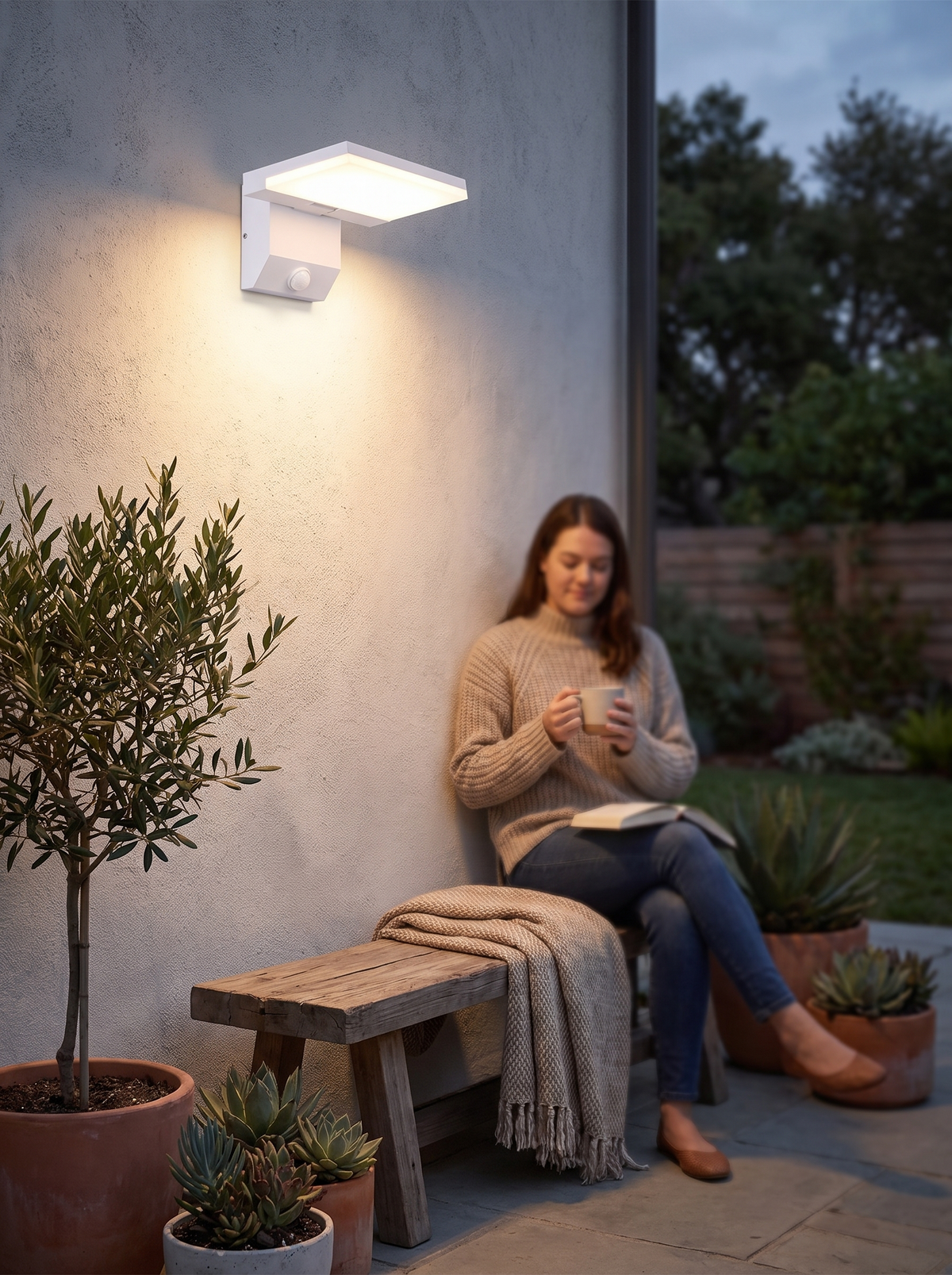 Pivoting heads of the LumiFold wall light angled down onto a step